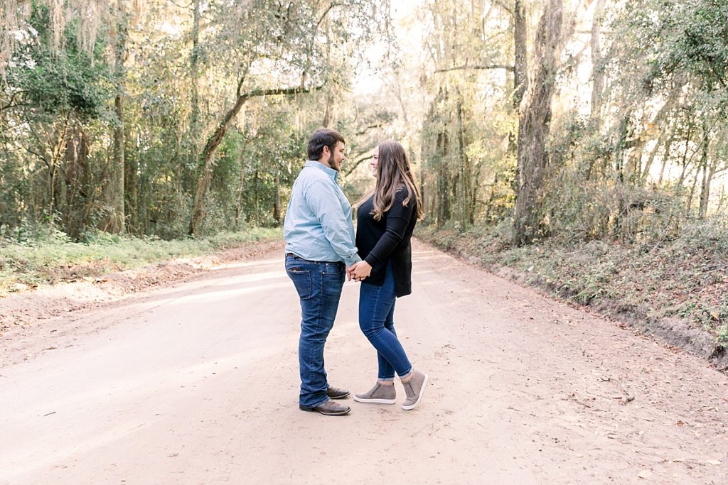 Couple poses on dirt road in Lake Park