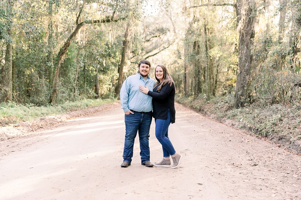 Couple poses on dirt road in Lake Park for family session