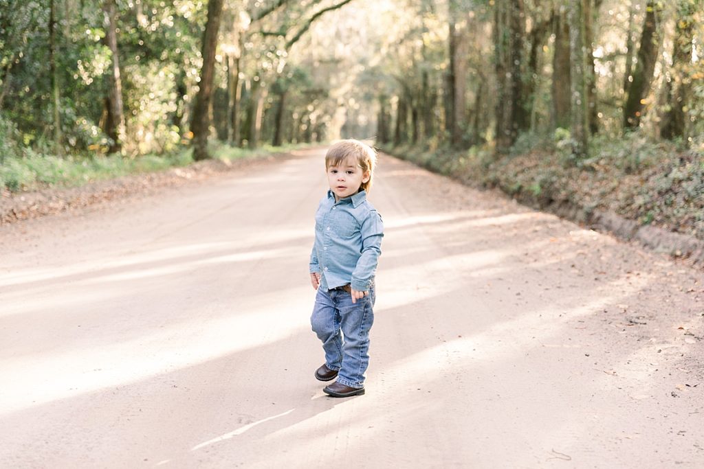 Little boy poses on dirt road in Lake Park