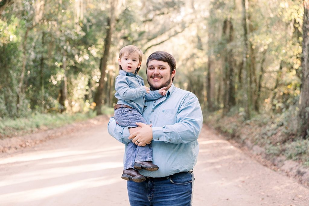 Dad poses with son for family portraits in Lake Park