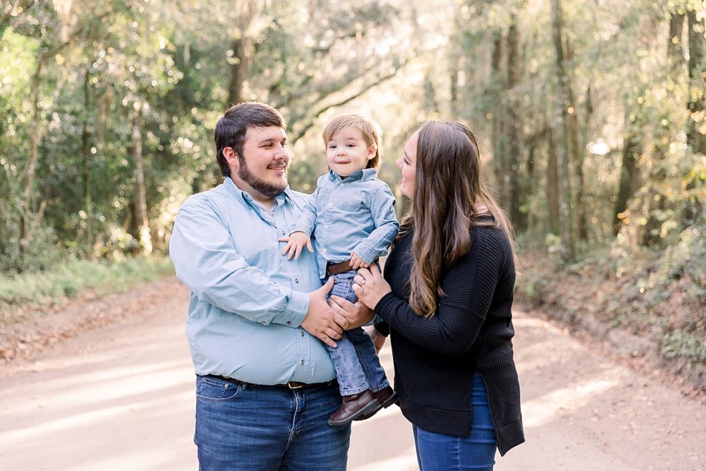 Family of three on dirt road for portraits